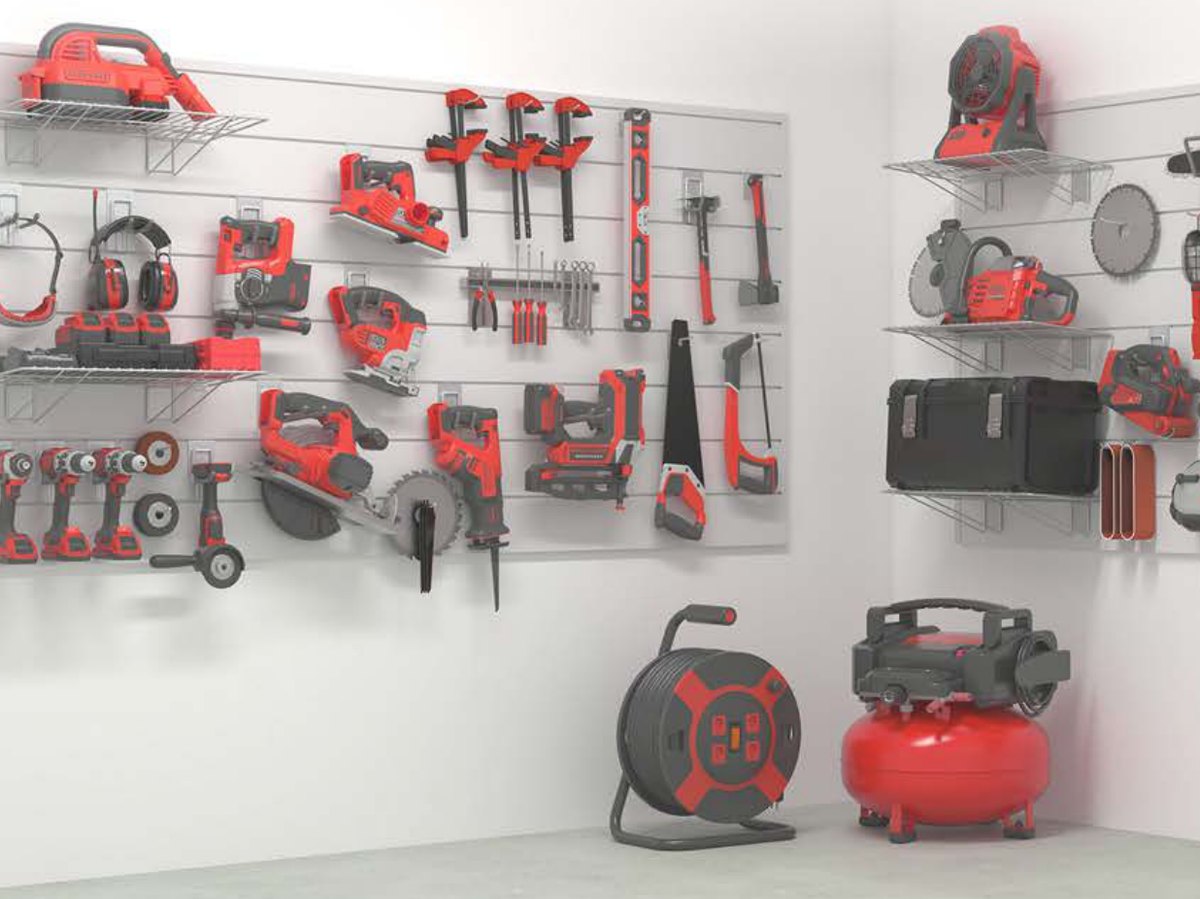 A garage wall of grey PVC slatwall holding power tools, clamps, a ladder and a compressor on hooks and shelves